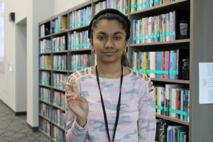 Trisha Jha poses for a picture in the JHS library on October 6th. 