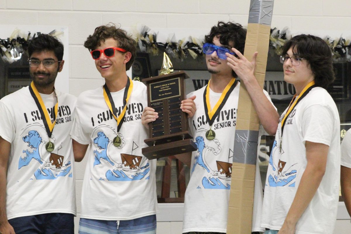 "Sunset Racing" crewmembers accept their awards after a victorious finish in First Place. 