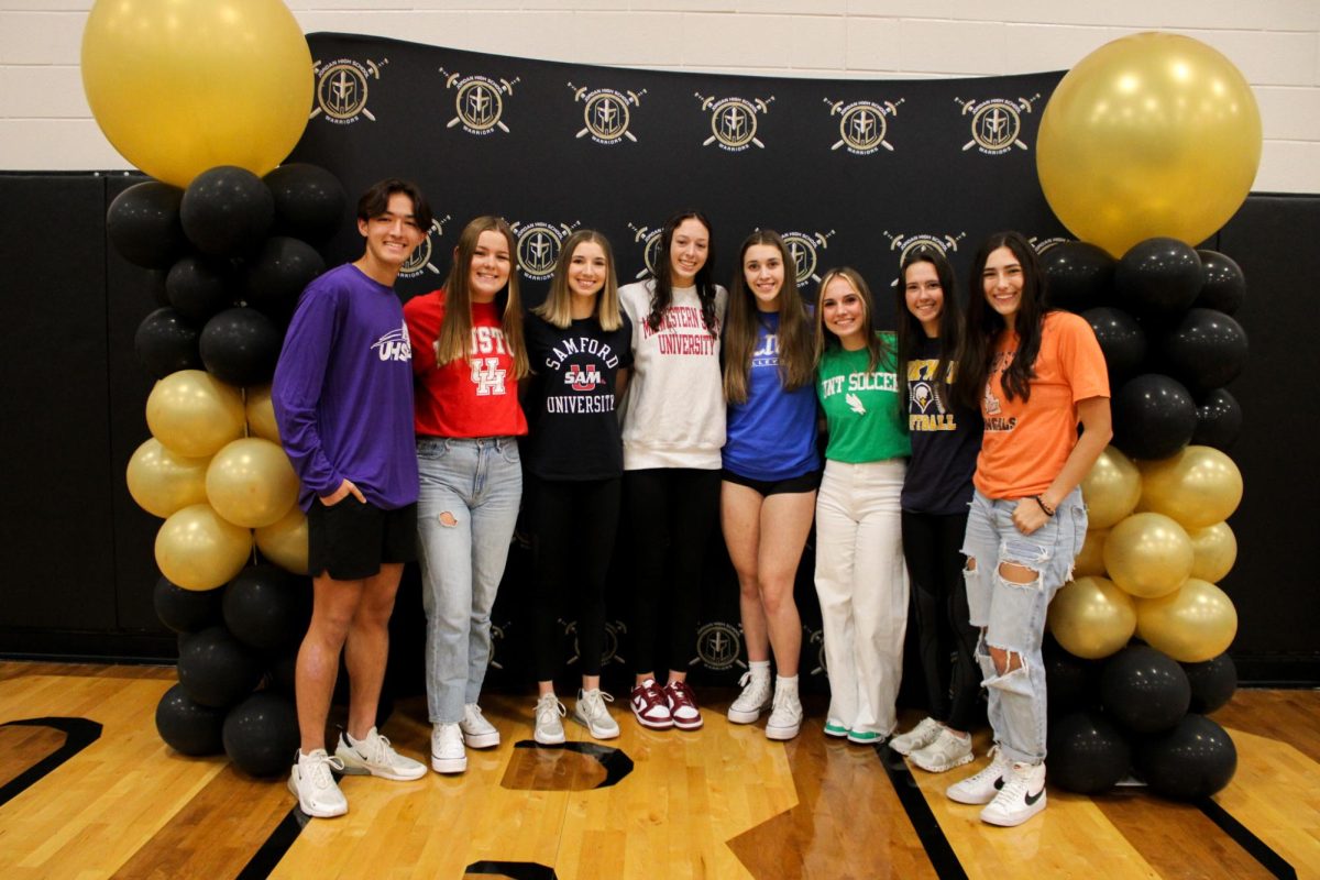 Athletes pose together for the camera, commemorating their achievements. 
