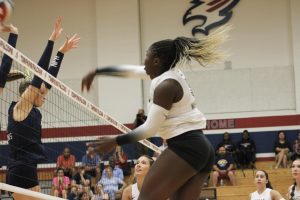 #16 Eti Osague going to spike the ball against Tompkins in the middle of a rally