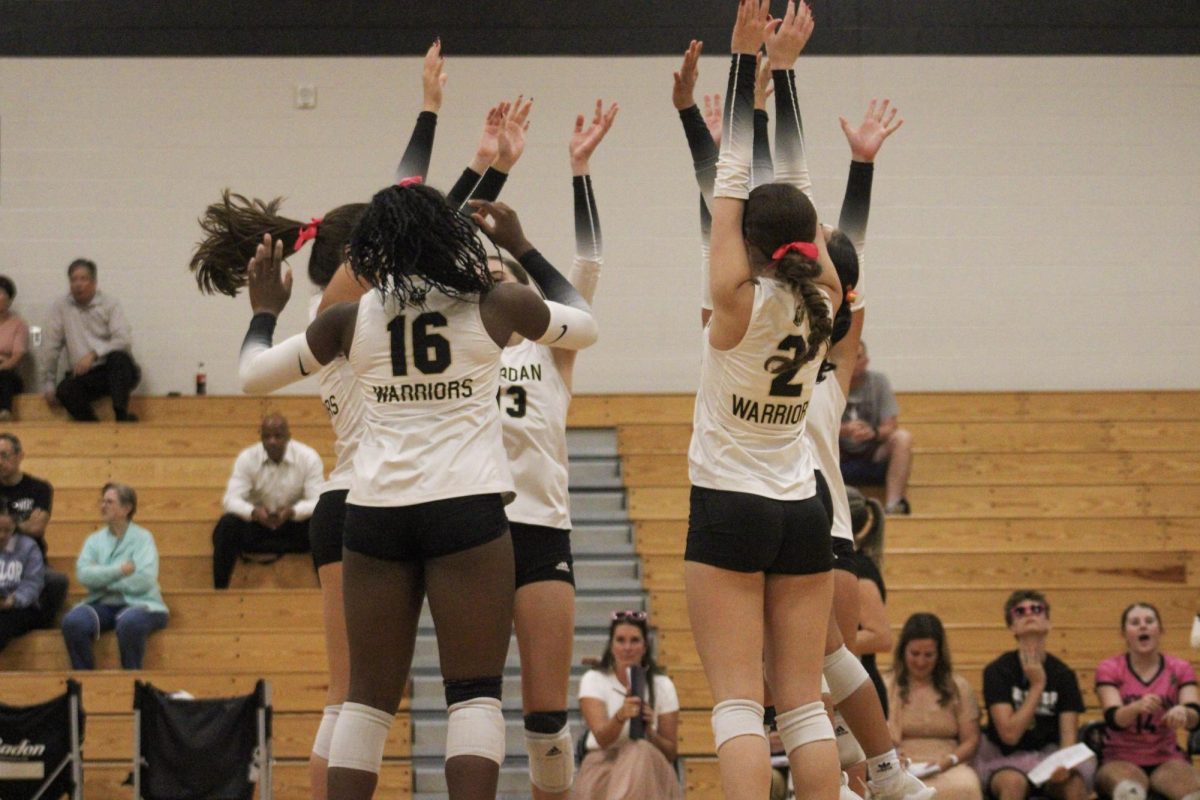 Varsity team celebrating after scoring an Ace